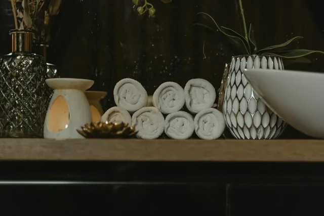 Rolled towels and candles in a calm spa setting